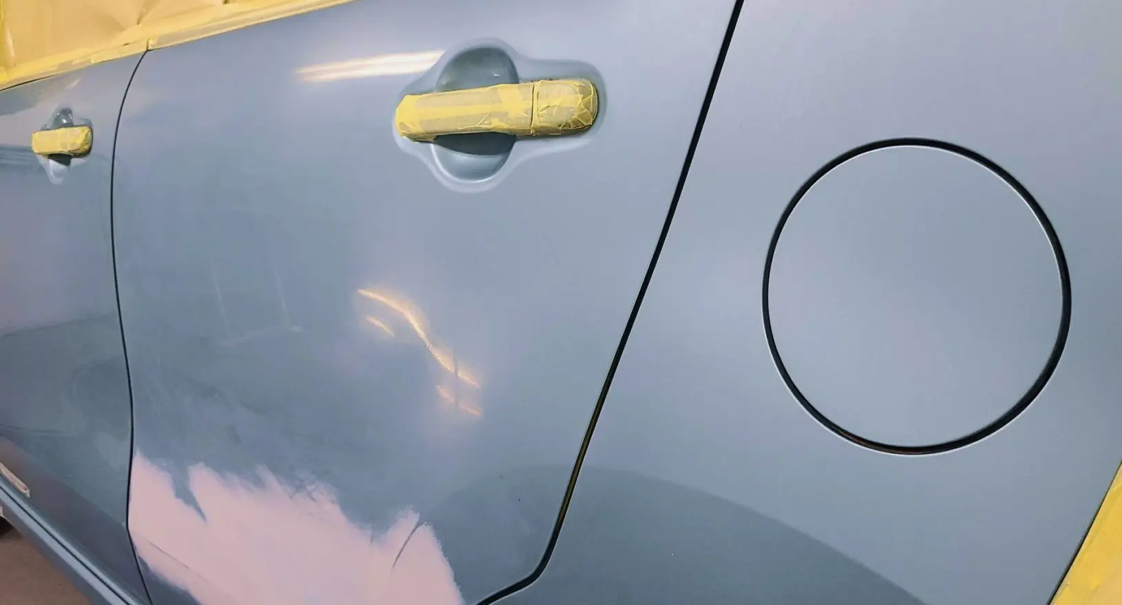 塗装作業のためにマスキングされた車のドア